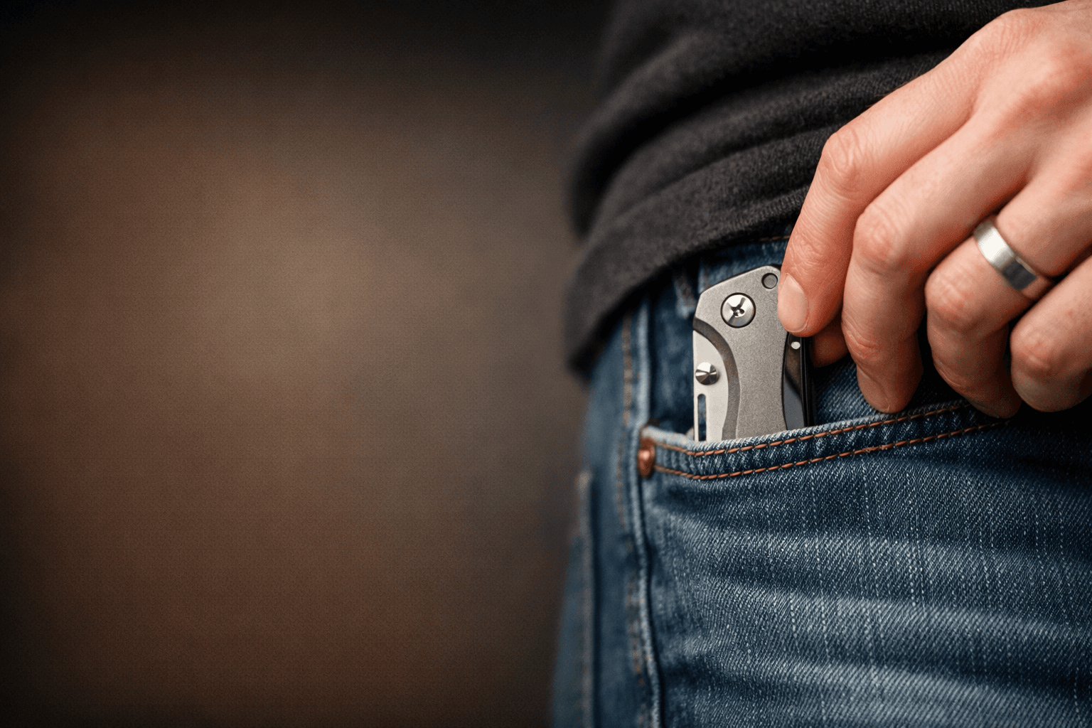 Pocket knife clipped in denim pocket